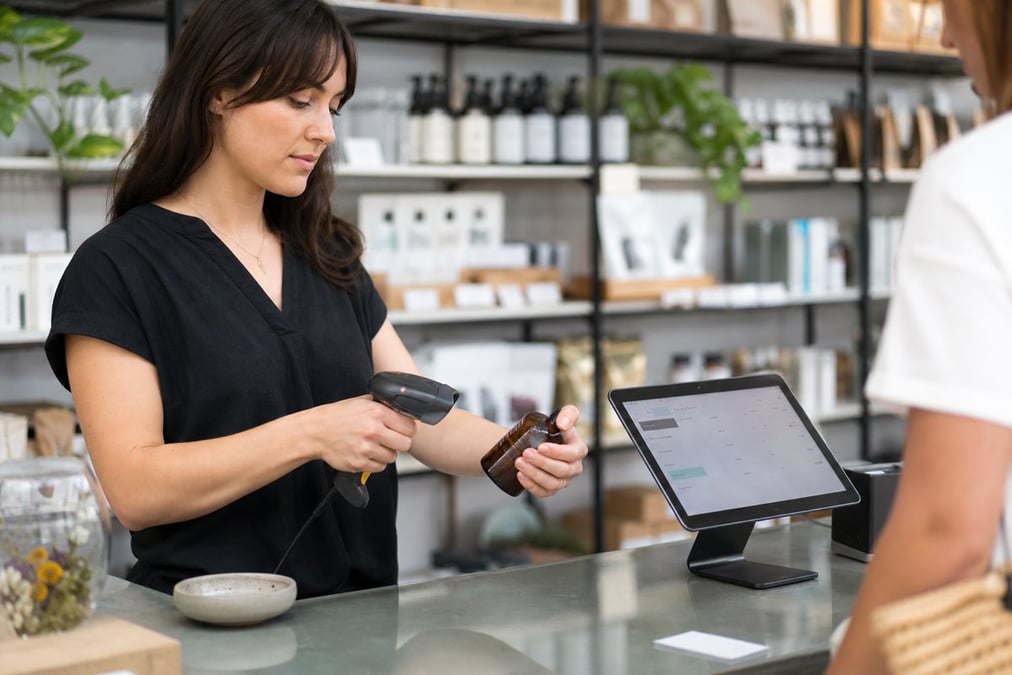 A sleek tablet point-of-sale system in a stylish coffee shop environment.