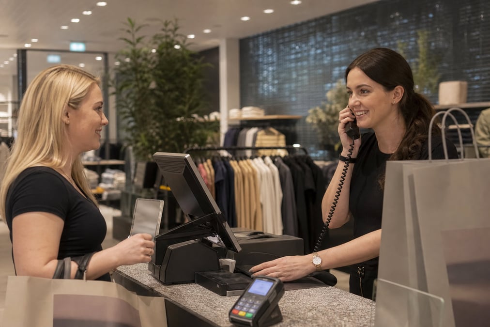 Person making a contactless payment using a smartwatch and a payment terminal.